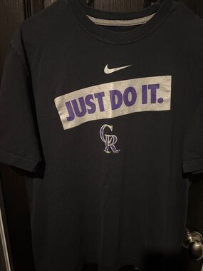 Nike Black Tee with Purple and Silver "Just Do It" and Rockies Logo